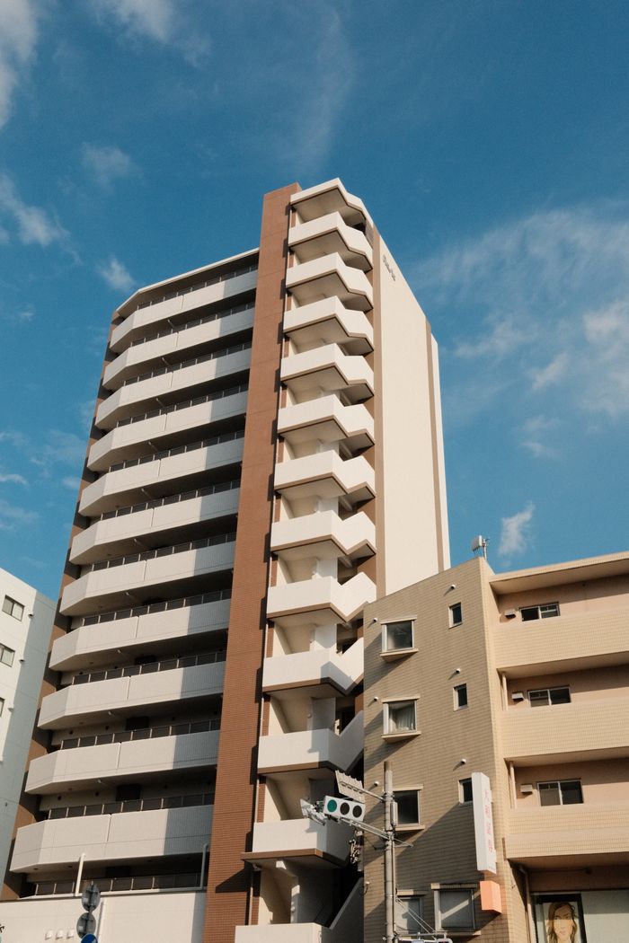 Vertical high-rise building captured on a clear day, reflecting modern architecture and urban living.